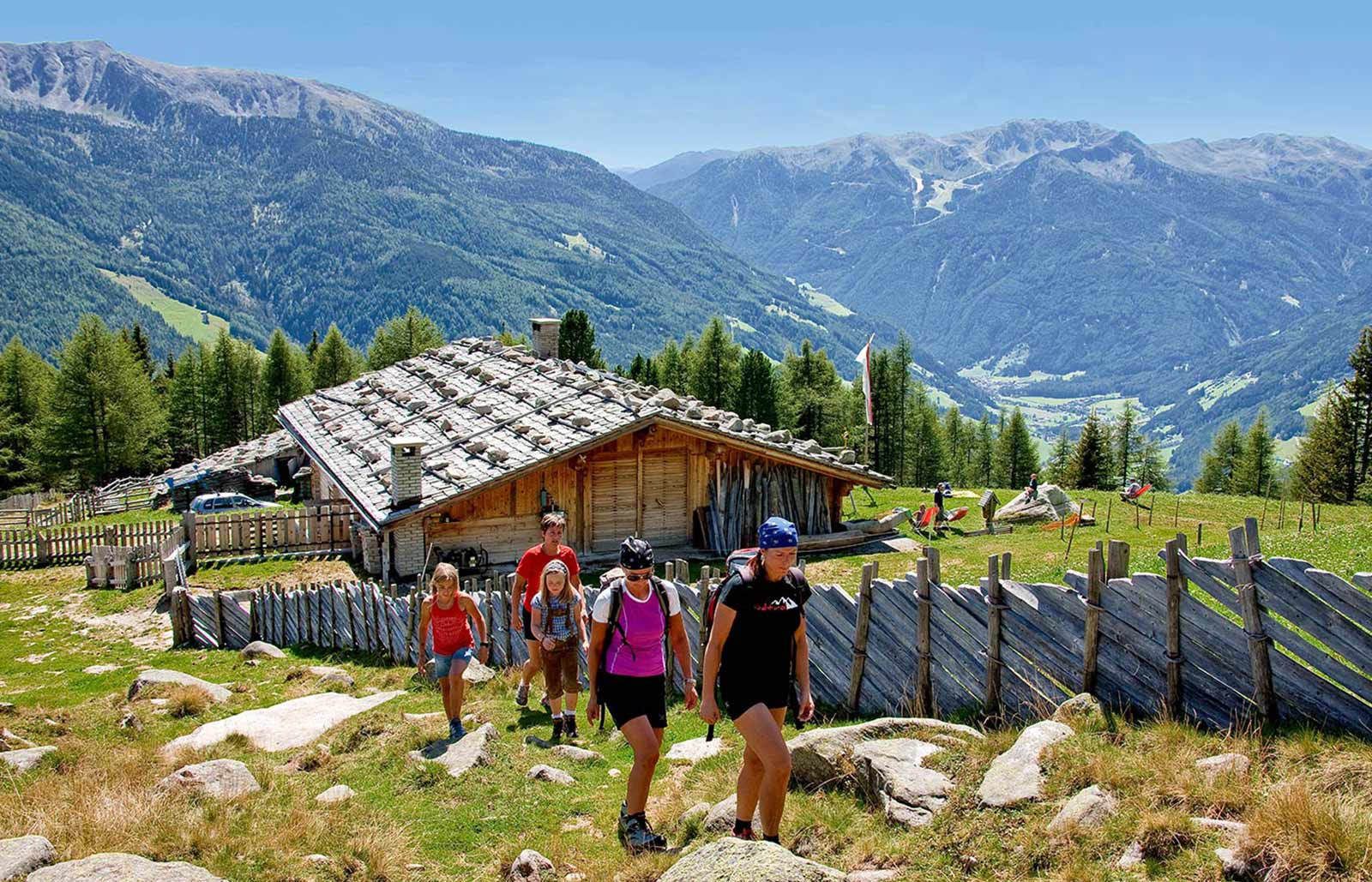 A group is hiking in the mountains around Lappago in Valle Aurina